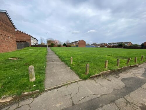 The Burns Road green space as it is now. It showed two sections of grass with a path going through it.