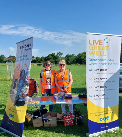 Greatwell Homes staff standing behind their stall with banners on display