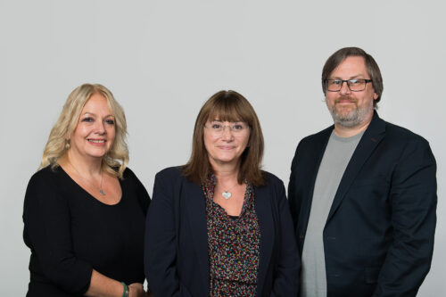 Three people standing next to each other standing in a line. Left to right - Julie Robinson, Jo Savage and Chris Holloway