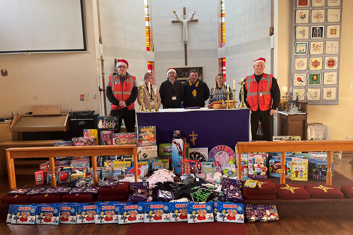 Staff from Fortem, Greatwell Homes and Father Ben with presents donated to St Marks Church for families and children in need.